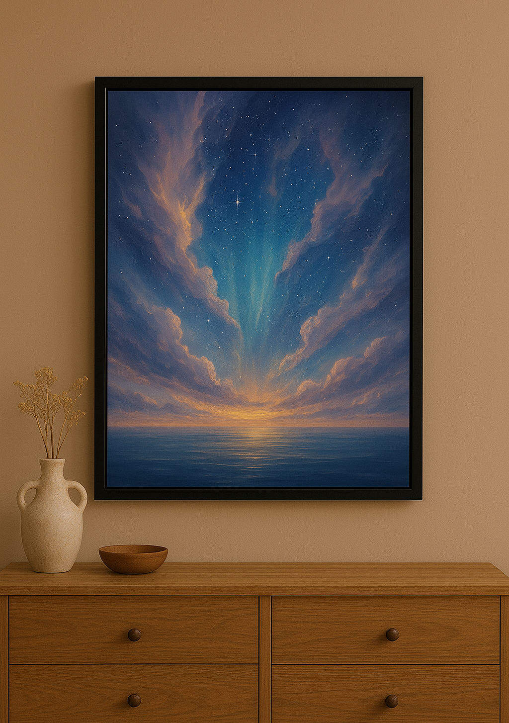 Framed artwork of a sunset over water on a wall above a wooden dresser with a vase and bowl.